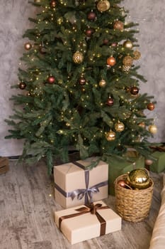 Home New Year's interior. Christmas tree with gifts, decorated with garlands. Cozy atmosphere of a home holiday, loft design of the room, Scandinavian style