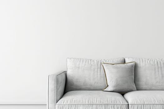 A white sofa with a gold trim pillow sits in front of a plain white wall.