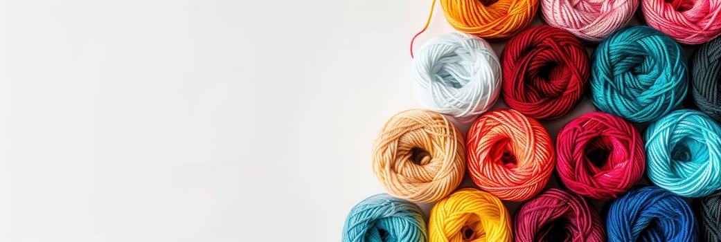 A vibrant display of yarn rolls in a grid pattern, set against a white background, ideal for creative projects and ample text placement.