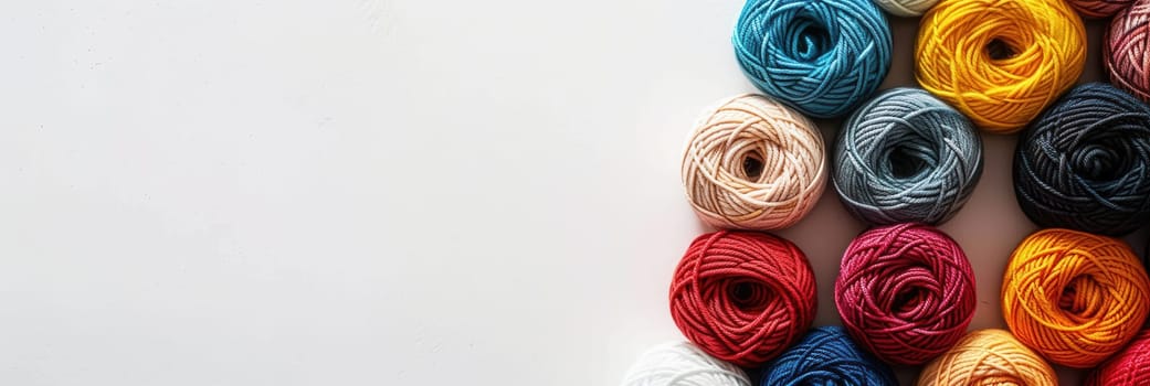 A grid of vibrant yarn rolls in various colors is displayed on a white background, providing a creative space for crafting and knitting enthusiasts.