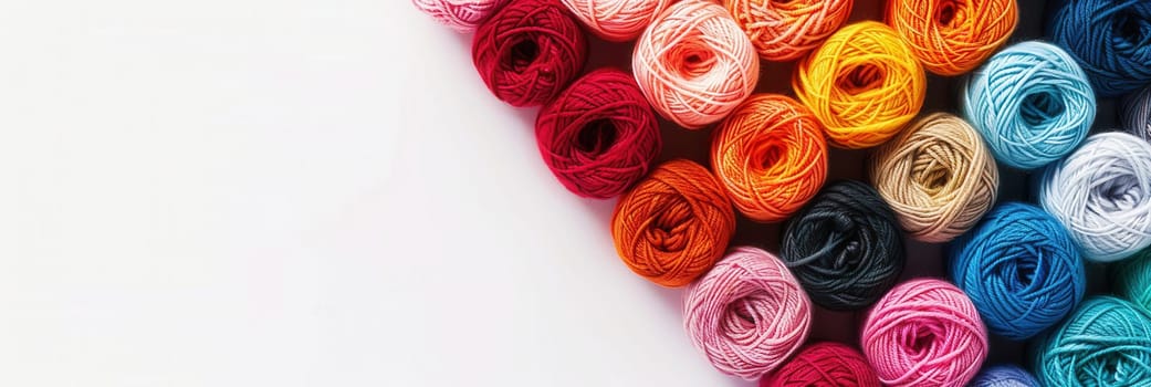 Colorful yarn rolls are arranged neatly in a grid, offering ample space for creative text placement, perfect for crafting inspiration and project ideas.