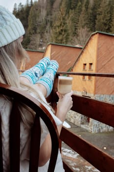 A young beautiful woman in warm handmade knitted clothes at home. . spring, winter season. Gaiters. Knee socks. Leggings.
