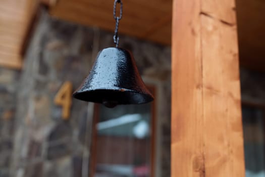 old bell on the facade of the house. The exterior of the building and design details are vintage