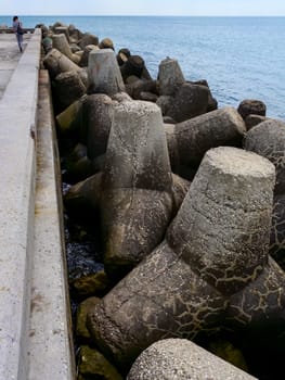 BULGARIA, VARNA - JUNE 06, 2013: coast protection structures, pier and concrete tetrahedrons for storm protection and pier destruction, Bulgaria
