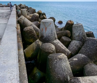 BULGARIA, VARNA - JUNE 06, 2013: coast protection structures, pier and concrete tetrahedrons for storm protection and pier destruction, Bulgaria