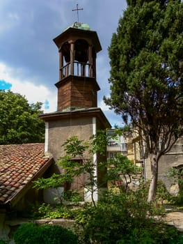 BULGARIA, VARNA - JUNE 06, 2013: 
old bell tower with a cross near the old church in Varna, Bulgaria
