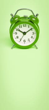 Green Alarm Clock on Green Background with Copy Space 3D Render Illustration