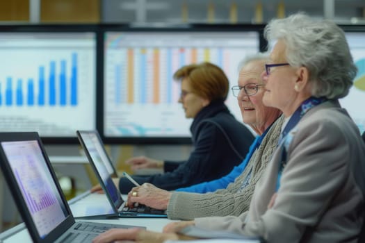 Elderly participants engage in a technology class at a community center, using laptops while analyzing charts and graphs displayed on large screens.