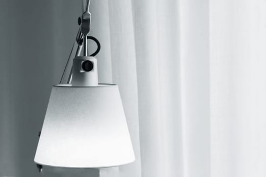 Vintage table lamp Interior design idea opposite the curtains in the backlight from the window. Minimalist interior idea.