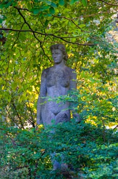 NANTES, FRANCE - SEPTEMBER 12, 2017: Sculpture of a naked woman in a park of plants in Nantes, France