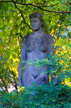 NANTES, FRANCE - SEPTEMBER 12, 2017: Sculpture of a naked woman in a park of plants in Nantes, France