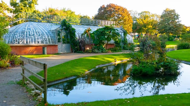 NANTES, FRANCE - SEPTEMBER 12, 2017: An original greenhouse near an artificial lake in a botanical garden in Nantes, France