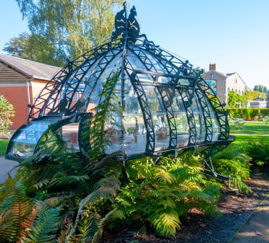 NANTES, FRANCE - SEPTEMBER 12, 2017: An original greenhouse near an artificial lake in a botanical garden in Nantes, France