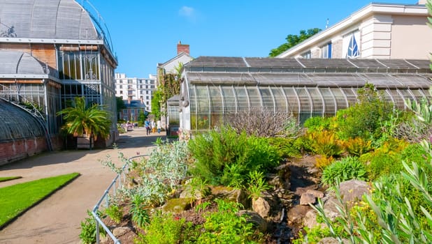 NANTES, FRANCE - SEPTEMBER 12, 2017: An original greenhouse near an artificial lake in a botanical garden in Nantes, France