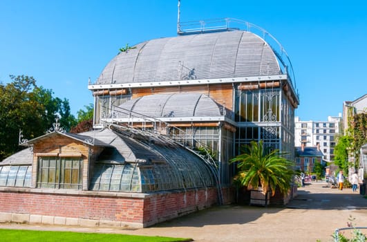 NANTES, FRANCE - SEPTEMBER 12, 2017: An original greenhouse near an artificial lake in a botanical garden in Nantes, France