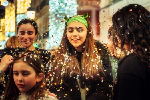 group of people, enjoying a festive moment with confetti floating in the air around them. The atmosphere appears to be joyous, as if they might be celebrating a special occasion or participating in a public festivity.