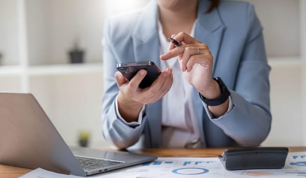 Close up mobile phone attractive Asian business woman using smartphone Space for text design online business woman working with mobile phone.