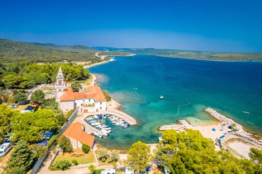 Franciscian monastery and idyllic beach in Nerezine aerial view, Mali Losinj island of Croatia