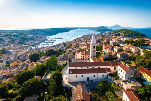 Town of Mali Losinj church and bay aerial panoramic sunset view, Losinj archipelago of Croatia