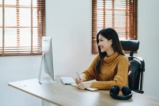 Beautiful young teen asian business woman meeting at on computer laptop with planning working on financial document, tax, exchange, accounting and Financial advisor.