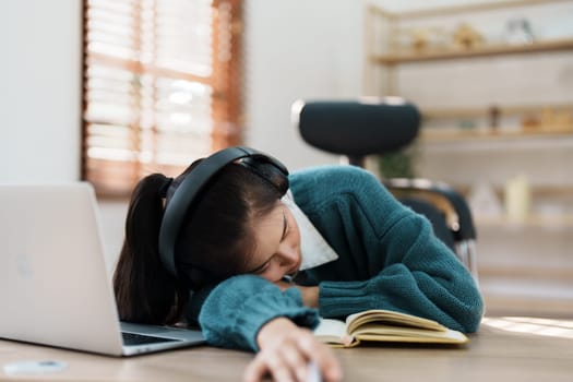 Studying online, beautiful Asian female student show symptoms burnout syndrome student studying online at home.