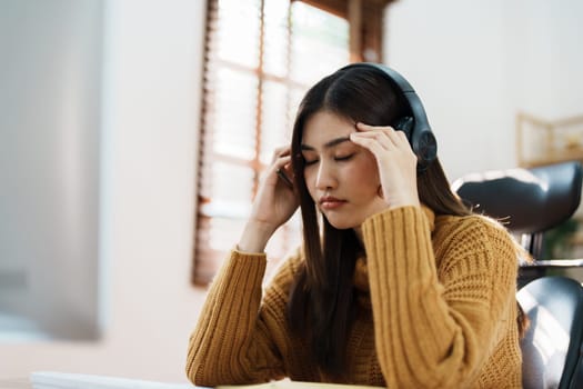 Studying online, beautiful Asian female student show symptoms burnout syndrome student studying online at home.