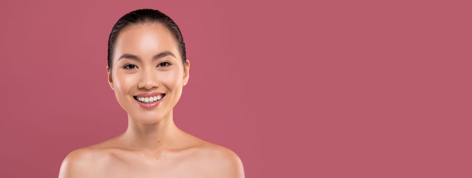 Portrait of attractive naked young japanese lady posing on purple studio background, cheerfully smiling at camera, copy space. Skin and body care for young women, healthy lifestyle concept