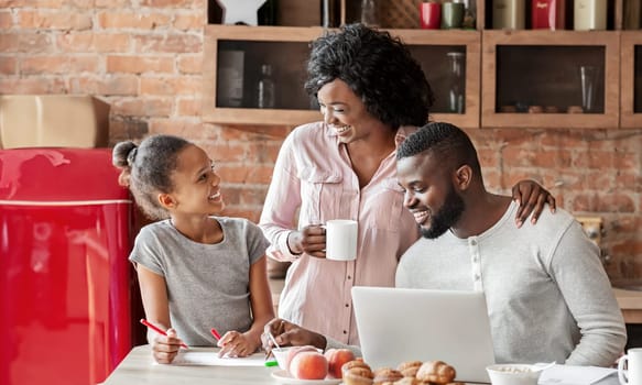 Quality time together. Happy black family spending morning at kitchen, having breakfast, planing vacation, copy space
