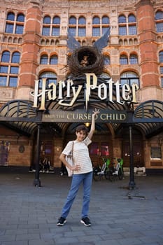 London, United Kingdom, july 18th 2024. Teenage girl in front of the facade of The Palace theatre in London. Play with the musical play Harry Potter and the Cursed Child.