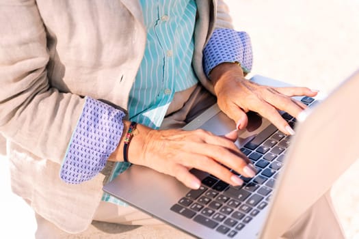 hands of an unrecognizable middle age woman using laptop, concept of technology and modern mature people lifestyle