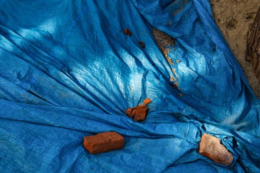 Plastic blue protective film covering construction materials. Abstract background and texture.
