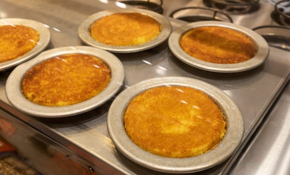 Knafeh Food, Sweet Cheese Pastry Made With Kadaifi, Traditional Arabic Dessert. Delicious Turkish Delight Kunefe On Metal Plate Behind Glass Case. Selective Focus, Horizontal Plane