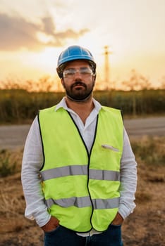 Wind park engineer inspection and progress check wind turbine. Portrait of outdoor worker.