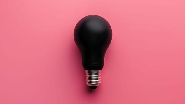 Black light bulb on pink background, minimalistic concept.