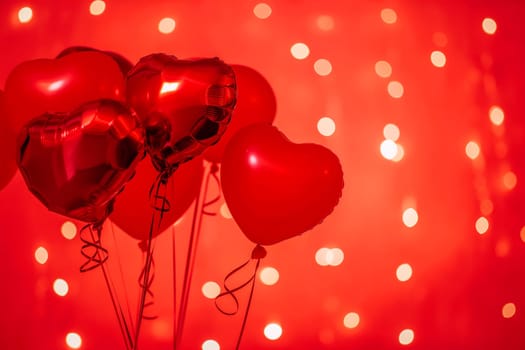 Red heart balloons with shiny bokeh background create a festive romantic celebration for Valentine party
