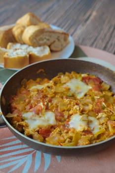 Turkish Menemen omelet in a frying pan.