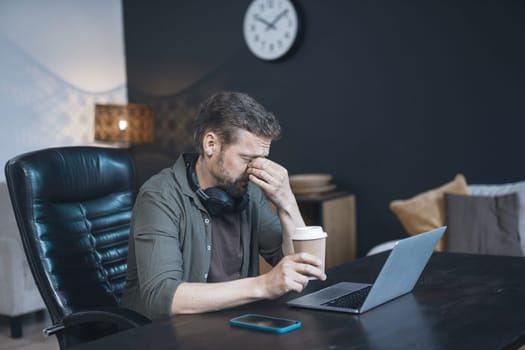 Tired man at work, visibly exhausted and fatigued, reflects toll of demanding corporate world. Challenges and strains faced by professionals as they navigate the pressures of their careers. High quality photo