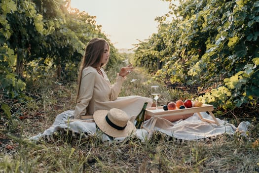 Picnic and wine tasting at sunset in the hills of Italy, Tuscany. Vineyards and open nature in the summer. Romantic dinner, fruit and wine.