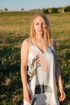 woman in a beautiful summer dress in nature in a clearing