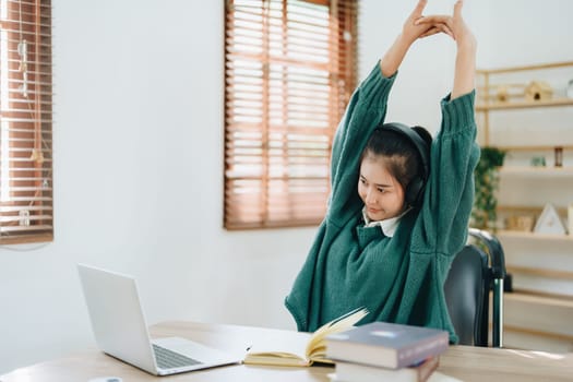 Studying online, beautiful Asian female student show symptoms burnout syndrome student studying online at home.