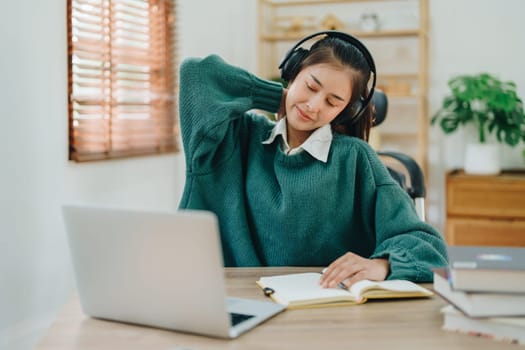 Studying online, beautiful Asian female student show symptoms burnout syndrome student studying online at home.