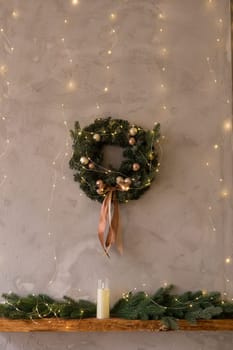 Home New Year's kitchen interior. Decorations with garlands and a Christmas wreath. Cozy atmosphere of a home holiday, loft-style interior design,