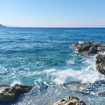Tranquil sea waves crashing on the rocks with a clear blue sky and a calm atmosphere.