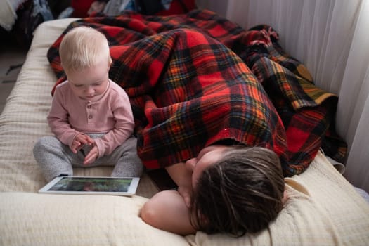caucasian child girl playing with a digital tablet at home.