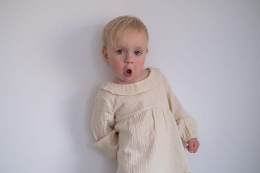 Funny toddler girl looking suspicious and curious. Beautiful child girl closeup portrait
