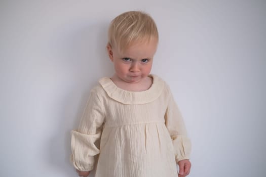 Funny toddler girl looking suspicious and curious. Beautiful child girl closeup portrait