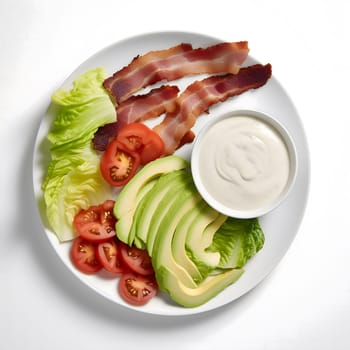 A colorful and appetizing salad featuring crispy bacon, sliced avocado, fresh tomatoes, and a creamy ranch dressing.
