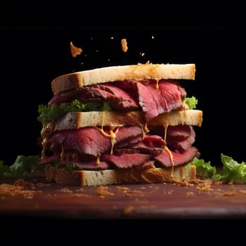 A close-up of a delicious roast beef sandwich with a dark background. The sandwich is stacked high with roast beef, lettuce, and a creamy sauce.