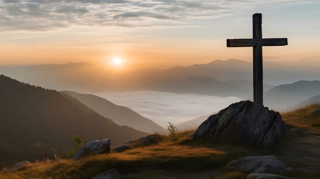 A wooden cross stands atop a rocky hill overlooking a breathtaking sunrise over mountains and clouds.