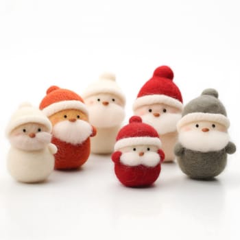 A collection of adorable felted Christmas ornaments, including Santa Claus, snowmen, and other festive figures.